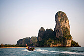 Longtail boat to Railay West with chalk cliff, Laem Phra Nang, Railay, Krabi, Thailand