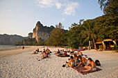 People sitting at white sandy beach of Hat Rai Leh, Railay West, Laem Phra Nang, Railay, Krabi, Thailand, after the tsunami