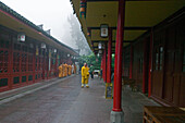 Monks at the courtyard of the Wannian monastery, Emei Shan, Sichuan province, China, Asia