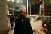 A monk standing at the courtyard of Xuandu monastery, Heng Shan South, Hunan province, China, Asia