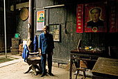 village barber, Mao portrait, courtyard of timber house in Chengkun, ancient village, living museum, China, Asia, World Heritage Site, UNESCO