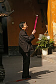Praying woman holding incense sticks, Putuo Shan, Zhejiang province, China, Asia