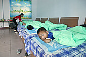 Kung Fu training at kindergarten age, at one of the many new Kung Fu schools in Dengfeng, very young pupils in the dormitory at one of the new Kung Fu Schools in Dengfeng, near Shaolin, Song Shan, Henan province, China, Asia
