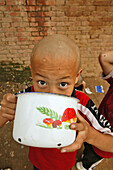 young boy at breakfast,  one of many new Kung Fu schools in Dengfeng, near Shaolin, Song Shan, Henan province, China, Asia