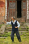 Taichi master demonstrating Taichi in front of his old house at the foot of Mount Wudang, Wudang Shan, Taoist mountain, Hubei province, Wudangshan, Mount Wudang, UNESCO world cultural heritage site, birthplace of Tai chi, China