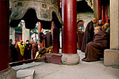 Buddhist monks honouring Wenshus at the birthday celebrations, red columns of temple, Xiantong Monastery, Wutai Shan, Five Terrace Mountain, Buddhist Centre, town of Taihuai, Shanxi province, China