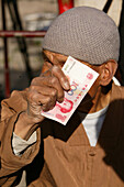 monk, money, offerings, Taihuai, Wutai Shan, Five Terrace Mountain, Buddhist Centre, town of Taihuai, Shanxi province, China, Asia