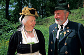 elderly couple in dirndl dress and traditional dress, pilgrimage to Raiten, Schleching, Chiemgau, Upper Bavaria, Bavaria, Germany