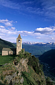 church of San Romerio above the valley of Puschlav with range of Bergamask alps in background, Puschlav, Grisons, Switzerland