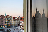 Old Town Square with reflection of St. Nicholas Church in the window, Staromestske Namesti, Old Town, Prague, Czech Republic