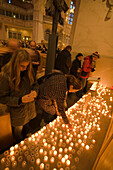 People lighting candles inside Dresden Frauenkirche, Dresden, Saxony, Germany