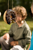 Children playing donut catching, children's birthday party