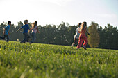 Children running over field, children's birthday party