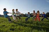 Children playing tug-of-war, children's birthday party