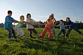 Children playing tug-of-war, children's birthday party