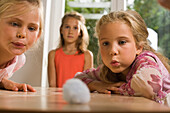 Two girls playing Blowing Cotton Wool, children's birthday party