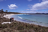 Hikers overlooking Soldiers Beach, Maria Island National Park, Tasmania, Australia