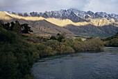 Sunlight falling on The Remarkables, Karawau River, near Queenstown, South Island, New Zealand