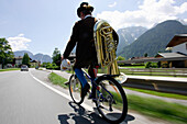 Musician on the way home after a music festival with a tuba, Lofer, Salzburg, Austria