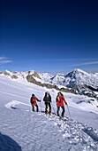 Three mountaineerers backcountry skiing at Maladeta, view to Pico de Paderna, Sacroux and Tuca de Salbaguardia, Pyrenees, Spain