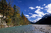 River of Rissbach with autumn colours and snow covered Karwendel range, Karwendel range, Tyrol, Austria