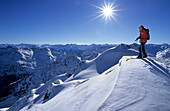 Backcountry skier at the summit of Gilfert, Tuxer Alps, Tyrol, Austria