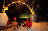 Two persons at start of illuminated toboggan-run, Nagelköpfel, Piesendorf, Salzburg, Austria