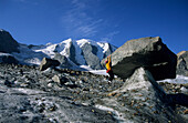 Mountaineerer doing a short-arm stretch at glacier table, glacier of Pers, Pontresina, St. Moritz, Bernina, Oberengadin, Grisons, Switzerland