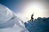 Snowboarder jumping off an overhang, Hexenboden, Zurs, Vorarlberg, Austria, Europe