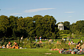 Sunbathing at Eisbach in front of Monopteros, English Garden, Munich, Bavaria, Germany