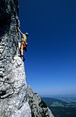 Climber on fixed rope route Pidinger Klettersteig, Hochstaufen, Chiemgau, Upper Bavaria, Bavaria, Germany