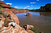 Man at end of Lathrop Canyon, Canyonlands National Park, Utah, USA