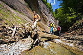 Three people canyon hiking through gorge Ofenloch, Canton St. Gallen, Switzerland