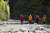 Canyoning at the swimm- and hike Canyon Raebloch, canton Bern, Switzerland. A group of people are floating in wetsuits  . The river Emme has erodet a 50 meter deep canyon into the rocks. It's a swim- and hiking canyon. Emmental, Europe, MR