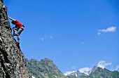 Young woman freeclimbing at rock, Bernese Oberland, Canton Uri, Switzerland, MR