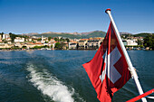 Motorboat on Lake Lugano leaving Lugano, Ticino, Switzerland