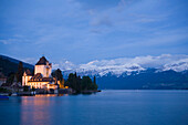 Illuminated Castle Oberhofen at Lake Thun in the evening, Oberhofen, Bernese Oberland (highlands), Canton of Bern, Switzerland