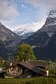 View over a wooden house to Bernese Alps, Grindelwald, Bernese Oberland (highlands), Canton of Bern, Switzerland