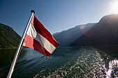 Austrian flag at stern of a ship on Lake Hallstatt, Hallstatt, Salzkammergut, Upper Austria, Austria