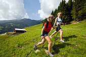 Two women nordic walking near Amoseralm 1198 m, Dorfgastein, Gastein Valley, Salzburg, Austria