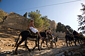 Tourists riding on donkeys to Acropolis, Lindos, Rhodes, Greece