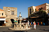 View over Platia Ippokratou with fountain and outside staircase of the Kastellania building (used as merchants' court and market inspectorate during the period of the Knights, the Public Library is situated here now), Rhodes Town, Rhodes, Greece, (Since 1