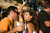 Couple flirting and dancing on sunday party at Sundance Beach Bar, Gennadi beach, Gennadi, Rhodes, Greece