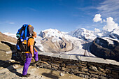 Male alpinist standing near Kulmhotel, the highest hotel in the Swiss Alps (3100 m) at Gornergrat and looking to Dufourspitze (4634 m), the highest mountain of Switzerland, Monte Rosa massif, Zermatt, Valais, Switzerland
