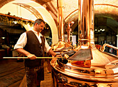 A man inspecting beer, Brewery, Griesbraeu, Murnau, Upper Bavaria, Bavaria, Germany