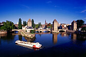Excursion boat in front of Ponts Couverts under blue sky, Strasbourg, Alsace, France, Europe