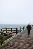 Person walking over pier, Dierhagen, Mecklenburg-Western Pomerania, Germany