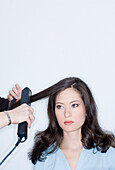 Young woman getting hairstyling