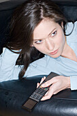 Young woman holding a remote control