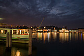 View from jetty over Lake Lucerne to illuminated Hotel Schweizerhof Luzern at night, Lucerne, Canton Lucerne, Switzerland